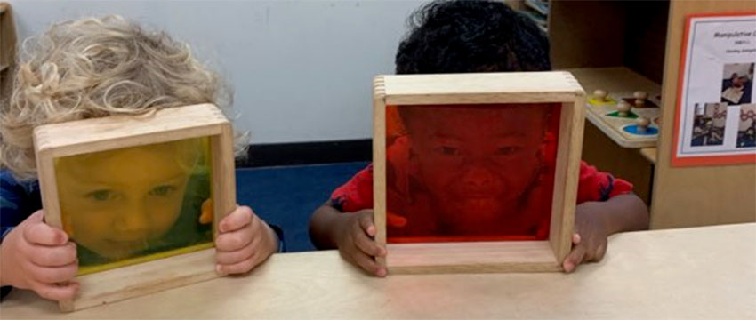 Two boys looking through colored film at CDFSC