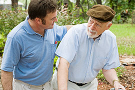 person helping an elderly man