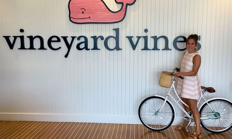 Student on bicycle at Vineyard Vines